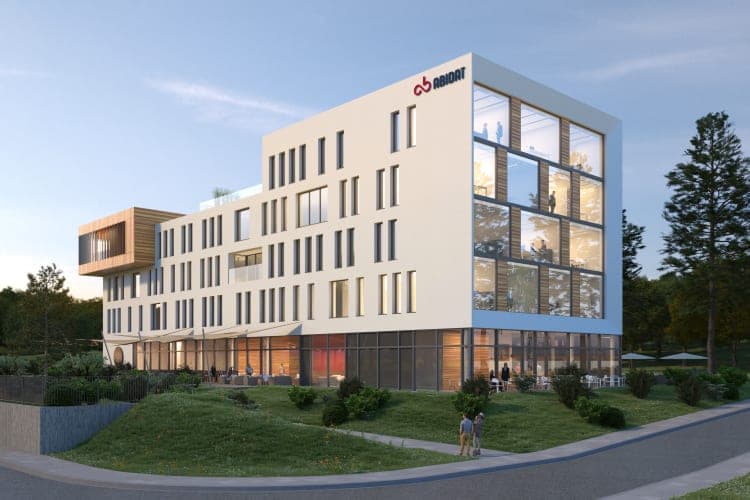 Bürogebäude Abidat in Fürth, Visualisierung der Ecklage mit gerahmter Glasfassade in der Abenddämmerung