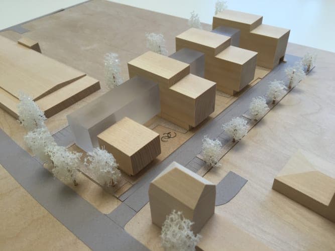 Timber site model of the office park with comb-like volumes, frosted acrylic blocks and white model trees
