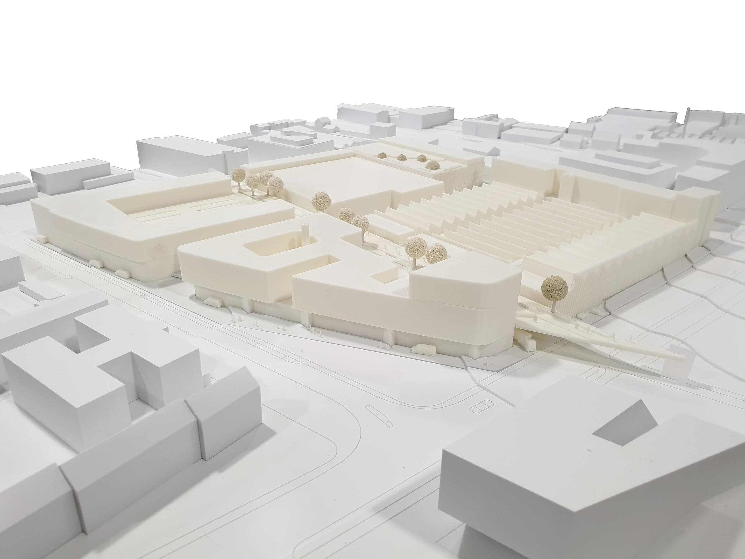 Modellfoto des Campus aus der Vogelperspektive mit Sheddachhallen, Höfen und umgebender Bebauung