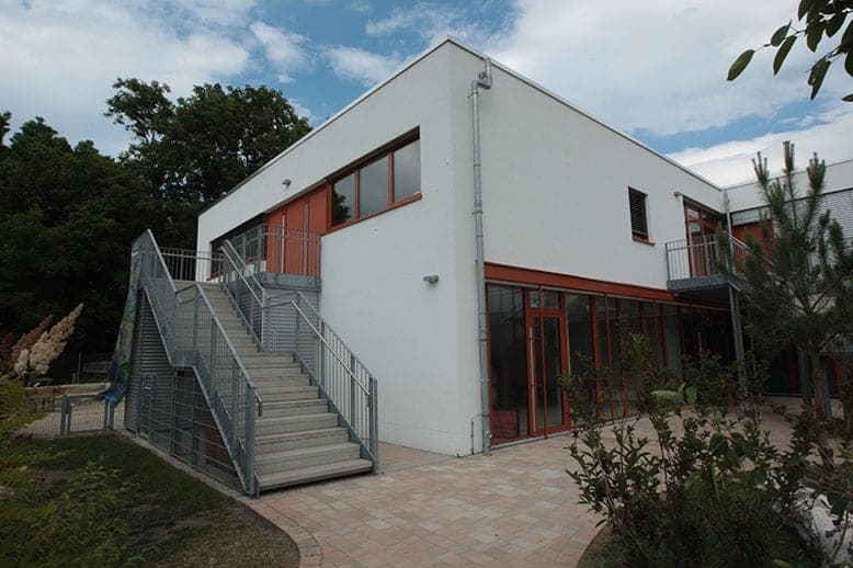 Corner of the nursery with an external staircase to the upper floor and full-height glazing to the terrace