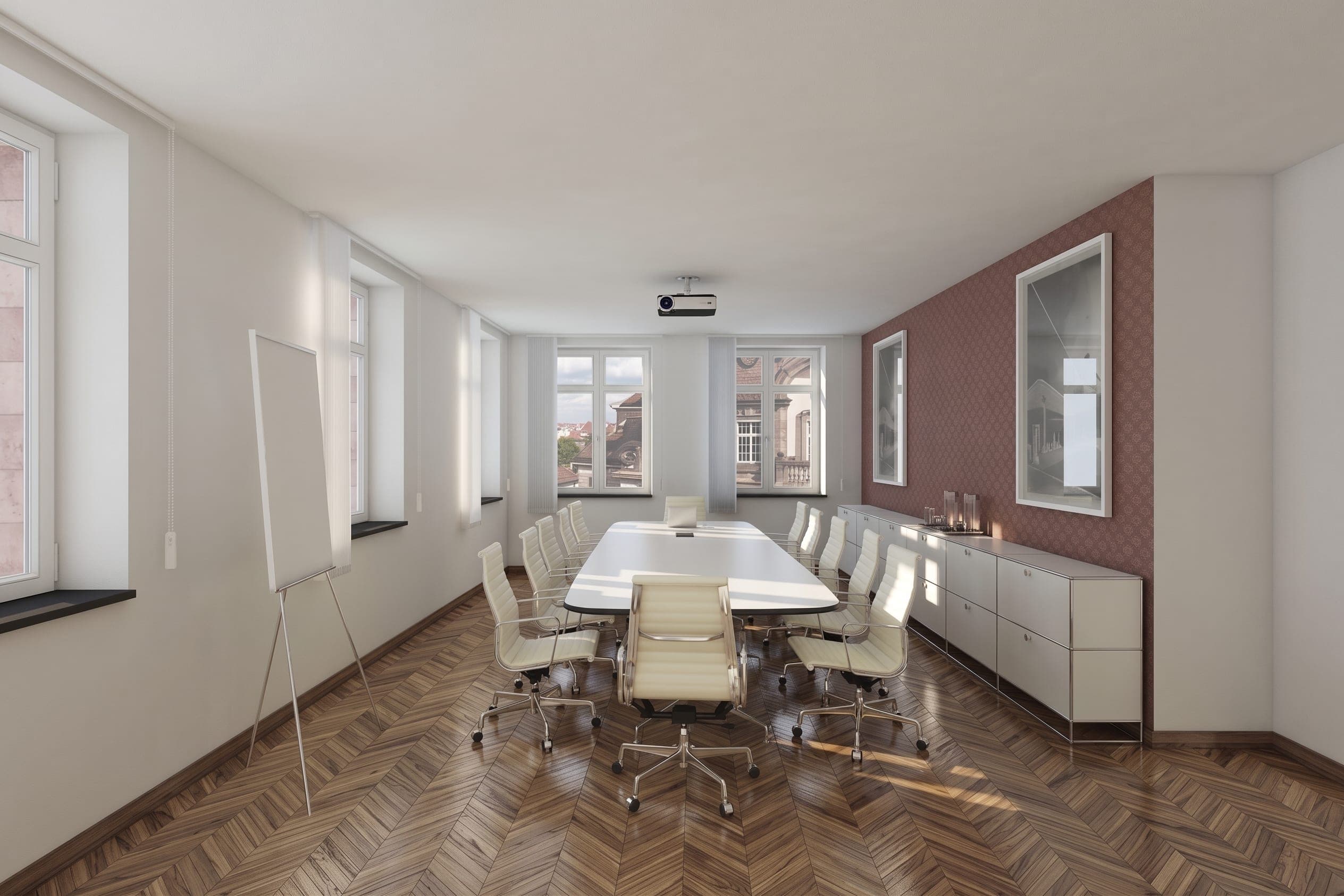 Meeting room in the office section as a visualisation, with a burgundy accent wall, a sideboard and a flip chart