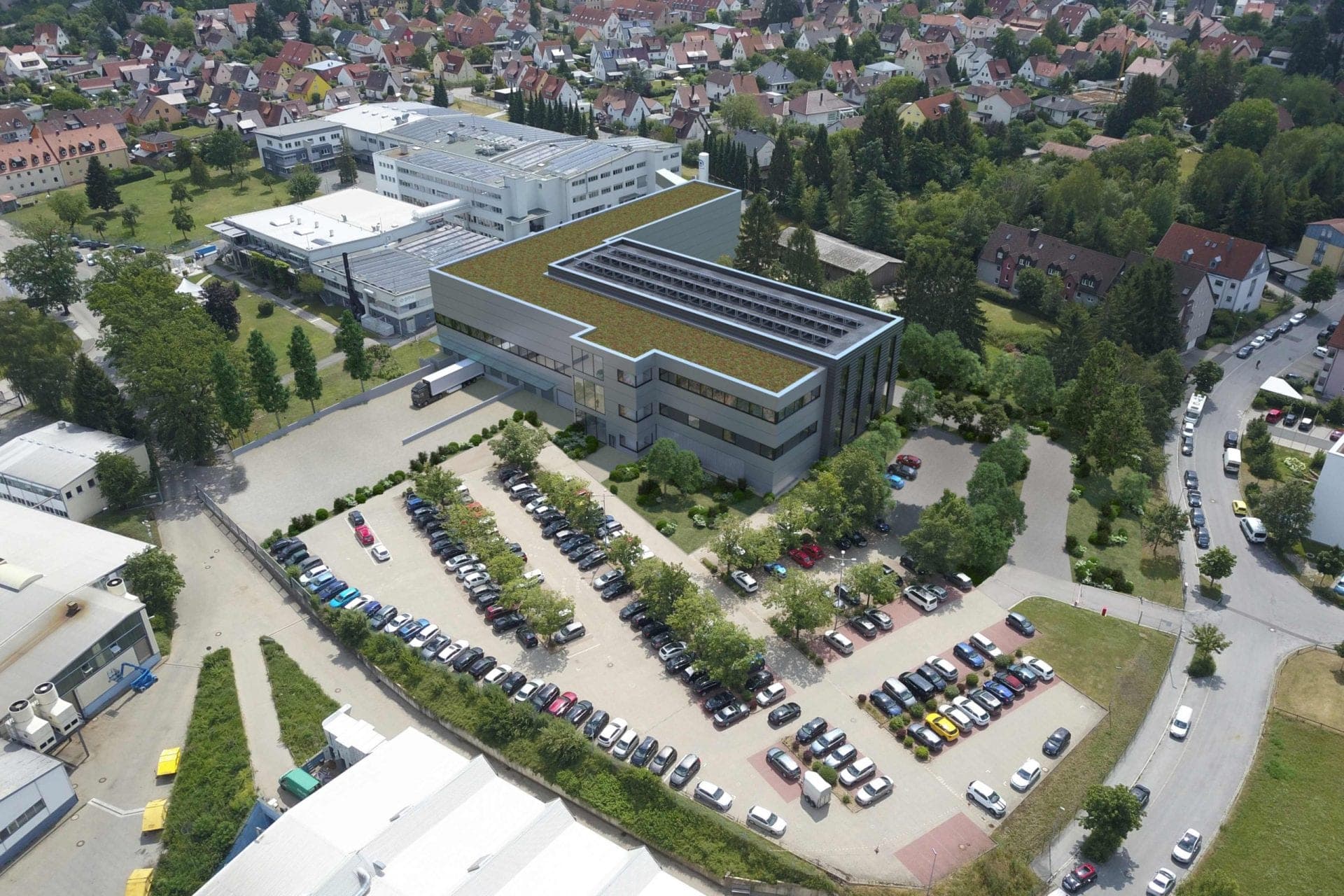 Warehouse and offices for E-T-A in Altdorf, aerial photomontage of the extension with a green roof beside the existing site