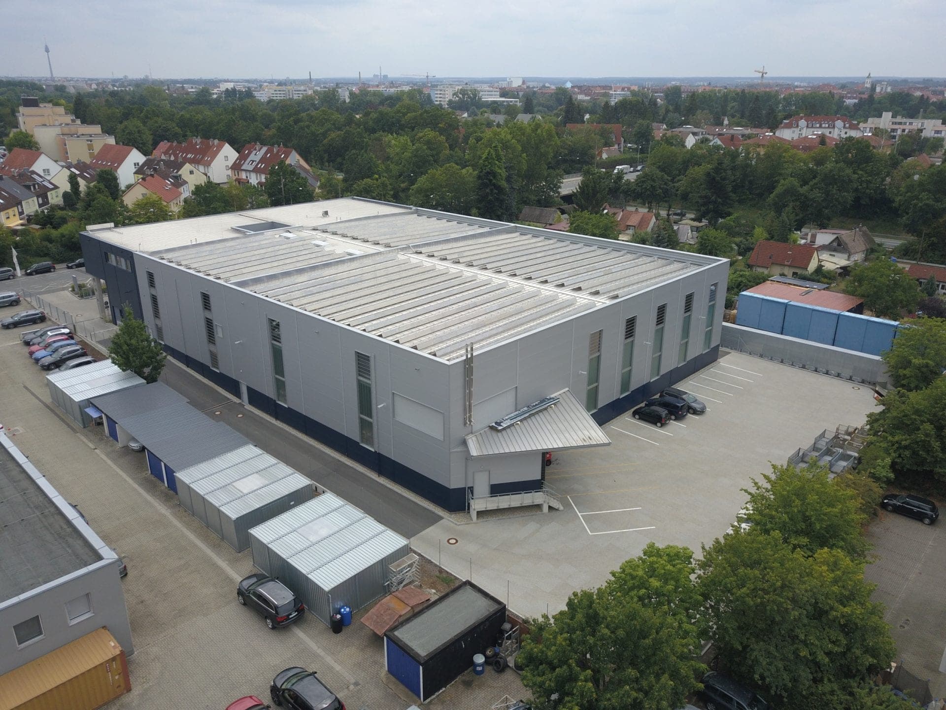 Aerial view of the warehouse from the rear with loading dock, yard and storage containers in the foreground