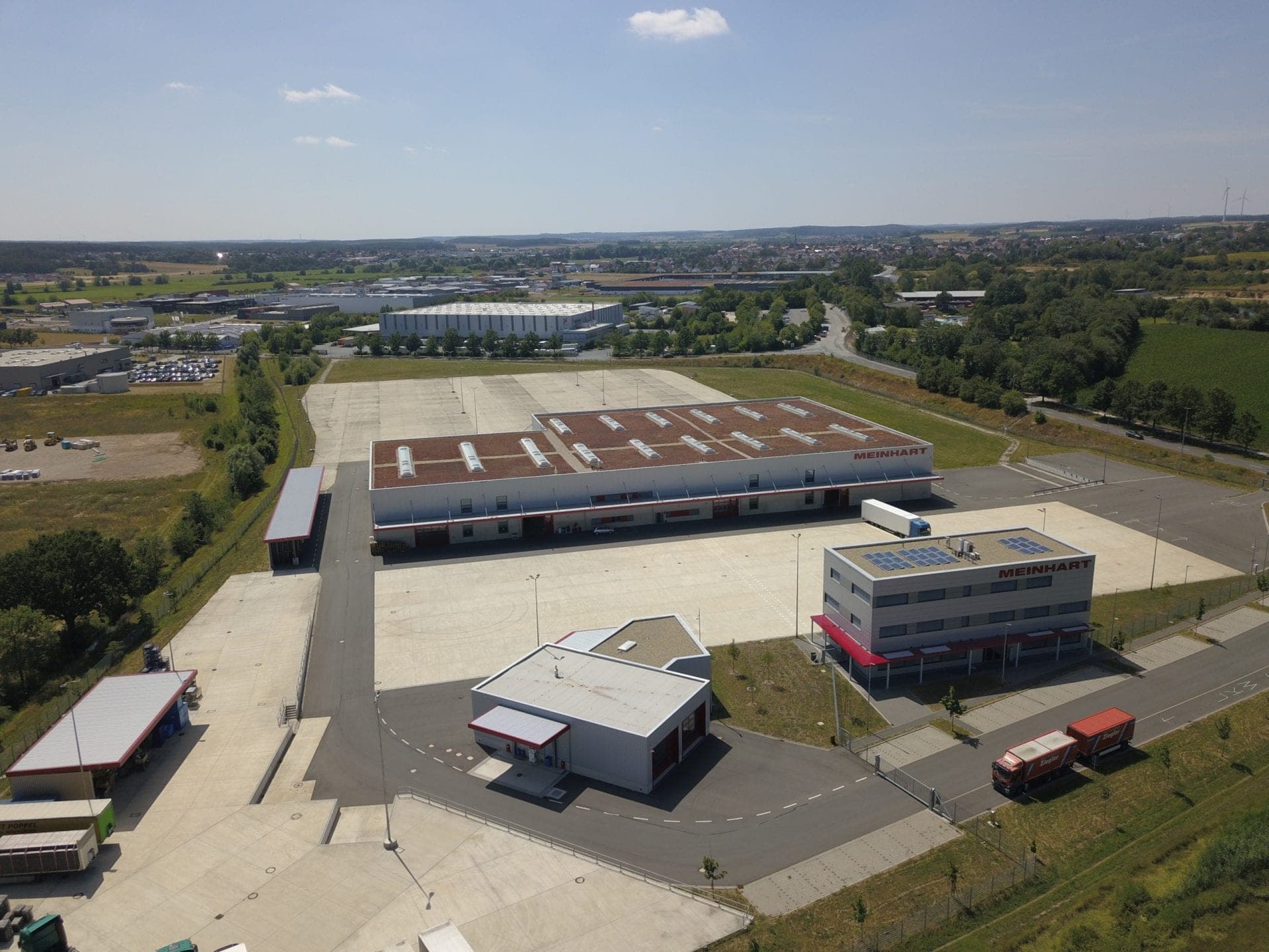 Aerial view across the extensive lorry manoeuvring area in front of the logistics hall in Höchstadt a.d. Aisch