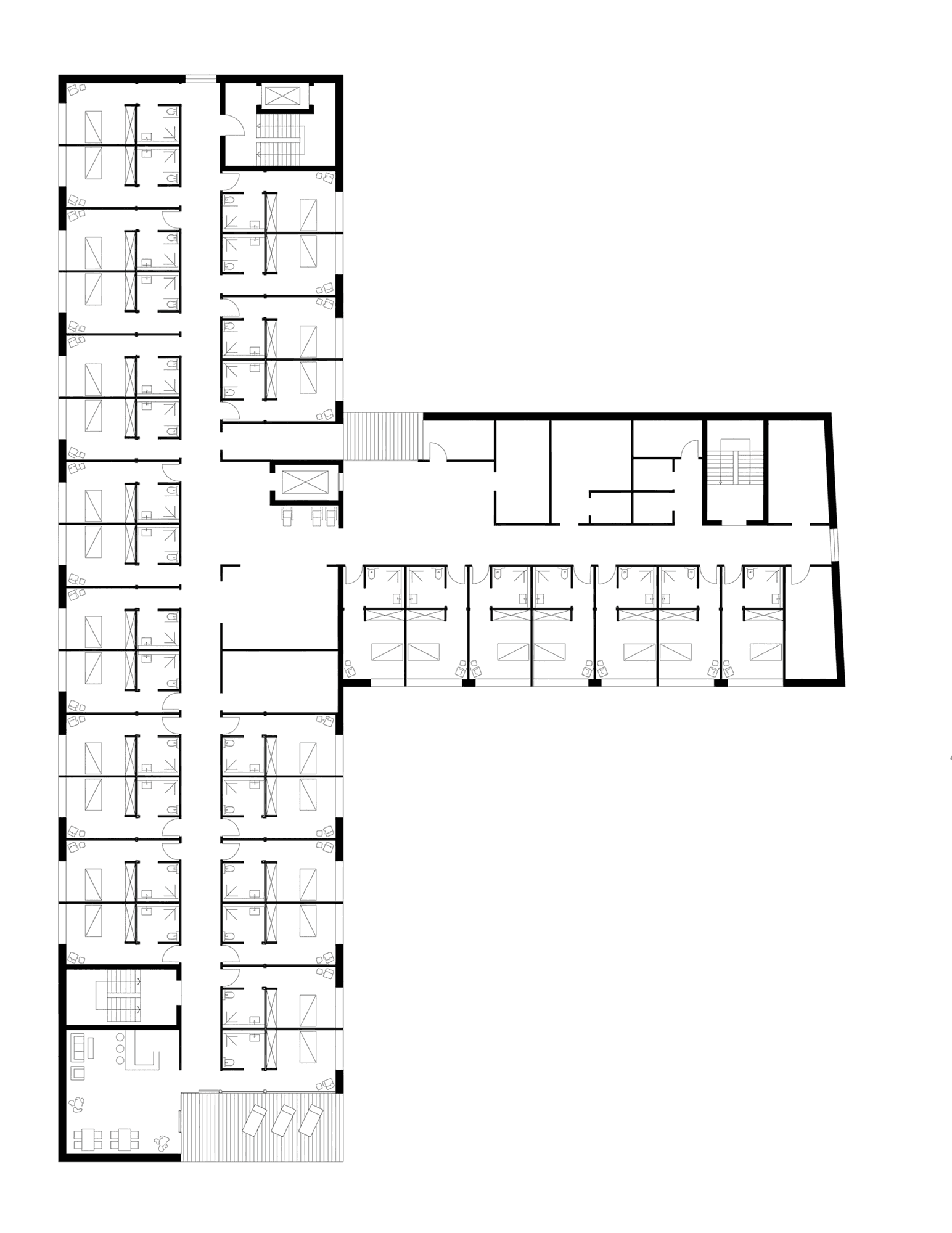 Floor plan of a care storey with single rooms and bathrooms either side of the corridor in the T-shaped building