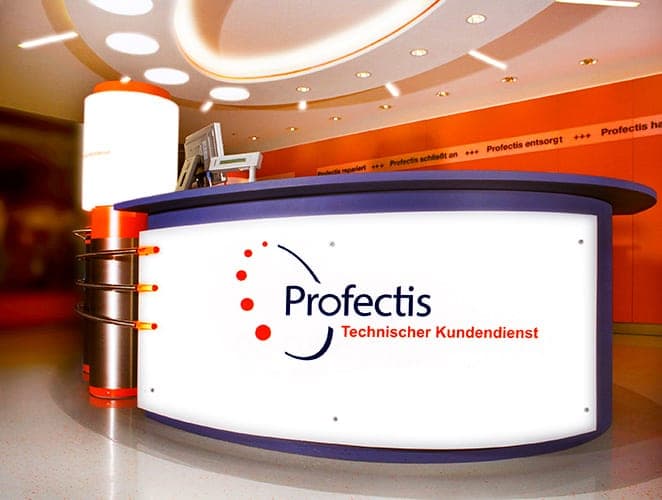 Close-up of the reception counter with the illuminated Profectis logo and a stainless steel column
