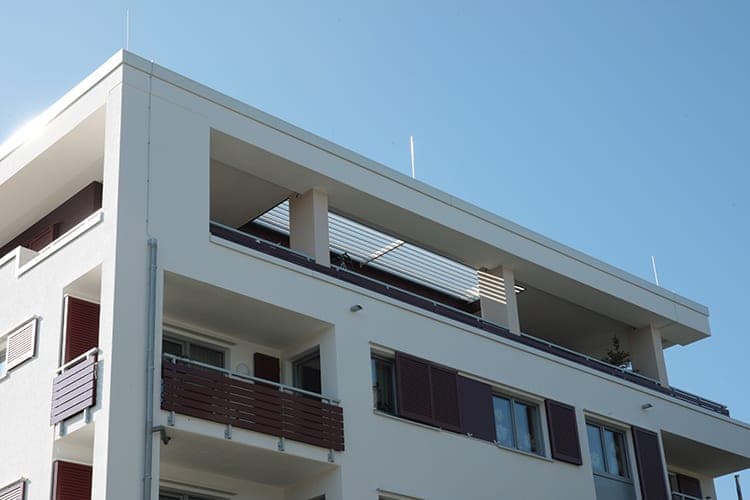 Set-back top floor with a louvred pergola over the roof terrace and balconies below