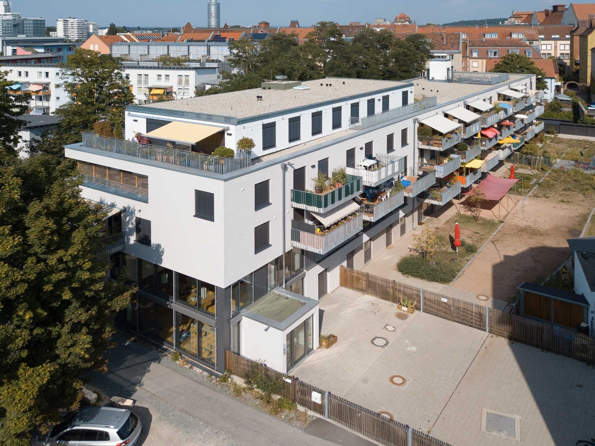 Multi-generational housing with day nursery in Nuremberg, aerial view of the balcony side and garden courtyard